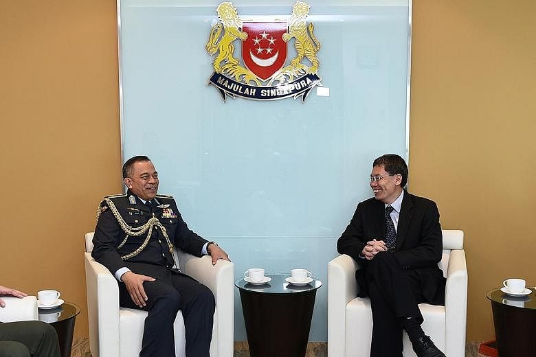 Commander of the Royal Brunei Air Force, Brigadier- General (U) Dato Seri Pahlawan Haji Wardi bin Haji Abdul Latip (left), with Second Minister for Defence Lui Tuck Yew at the Ministry of Transport yesterday morning. The general's three-day visit end