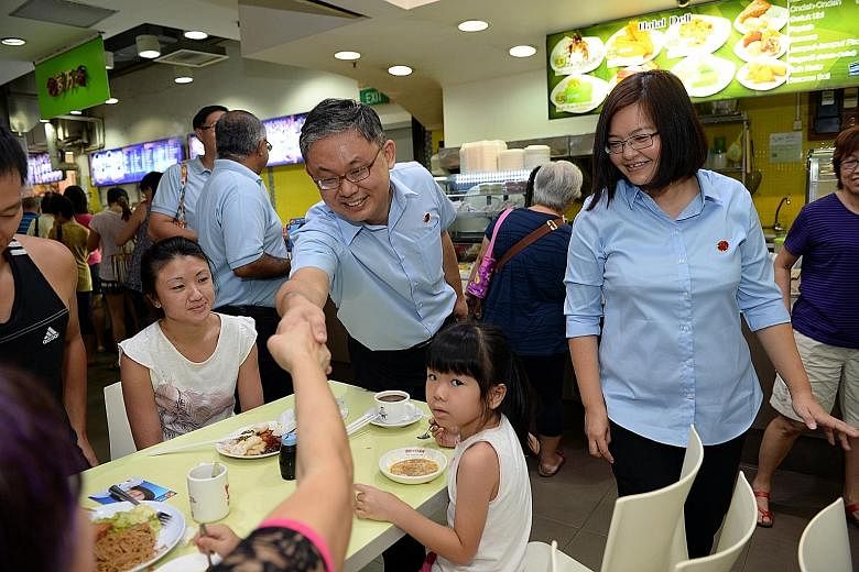 Mr Koh Choong Yong of the Workers' Party shaking the hand of a resident during a walkabout in Sengkang on Sunday. Dr Lam Pin Min of the People's Action Party visiting an Anchorvale resident during a walkabout in the ward last Saturday.