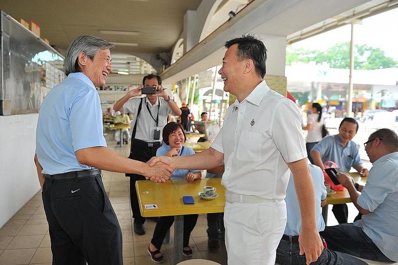 WP candidate Chen Show Mao (left) and PAP candidate Victor Lye greeting each other at Kovan Hougang Market and Food Centre yesterday. The next two days will be a battle to win over swing voters, with the daily schedules of both parties packed with wa