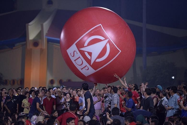 A giant Singapore Democratic Party inflatable ball got the crowd involved at last night's party rally at Woodlands Stadium.