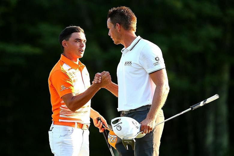 Rickie Fowler (left) being congratulated by Henrik Stenson after he won the Deutsche Bank Championship by one stroke. The American claimed his third PGA Tour title and moved to fifth in the world rankings.