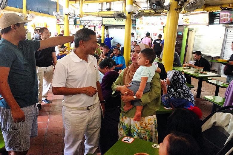 Dr Vivian Balakrishnan during a walkabout at Adam Road Food Centre on Sunday. A member of the public taking a selfie with Dr Chee Soon Juan at Adam Road Food Centre last Wednesday.