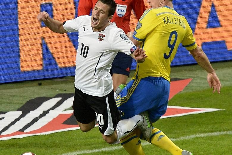 Austria's Zlatko Junuzovic (left) earns a penalty after he is fouled by Sweden's Kim Kallstrom during their Euro 2016 Group G qualifier. Austria won the game, played in Stockholm on Tuesday, 4-1.