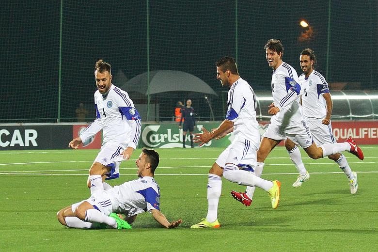 San Marino's Matteo Vitaioli (on ground) celebrating after scoring against Lithuania but the minnows could not hold on for a rare draw.