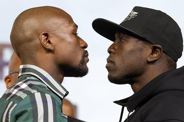 Floyd Mayweather (far left) and challenger Andre Berto in an intense face-off after their news conference at the MGM Grand Hotel & Casino in Las Vegas on Wednesday.