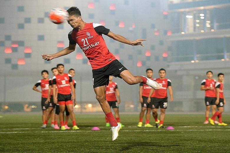 Safuwan Baharudin heading a ball during a LionsXII training session at ITE College Central in Ang Mo Kio yesterday.