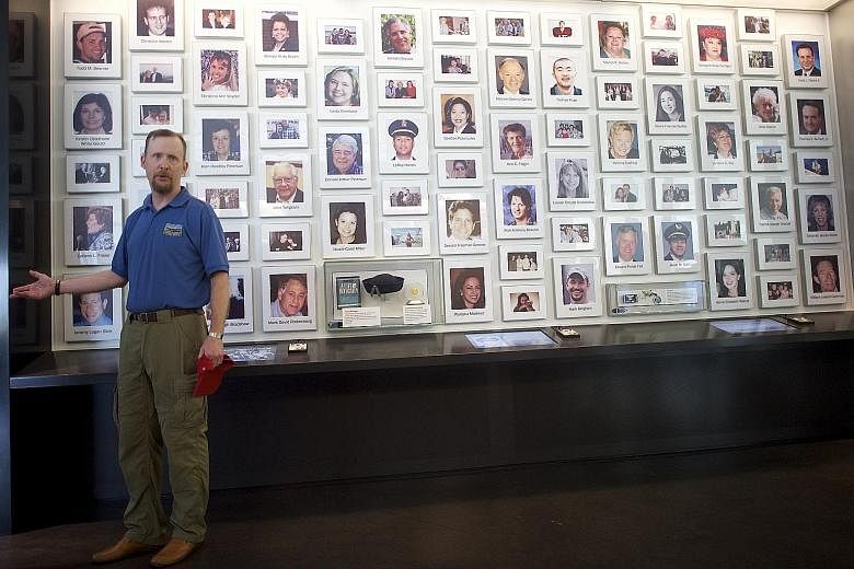Mr Gordon Felt, whose brother died on Flight 93, leading a tour through the Flight 93 memorial centre in Pennsylvania, US, on Wednesday. On display are remnants from the crash, including utensils and debris.