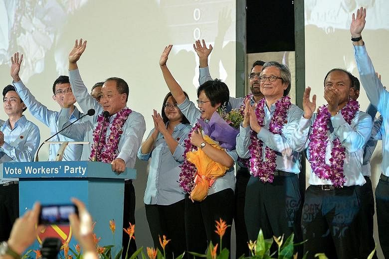 Workers' Party leader Low Thia Khiang (at podium) and his team celebrating their victory in Aljunied GRC.
