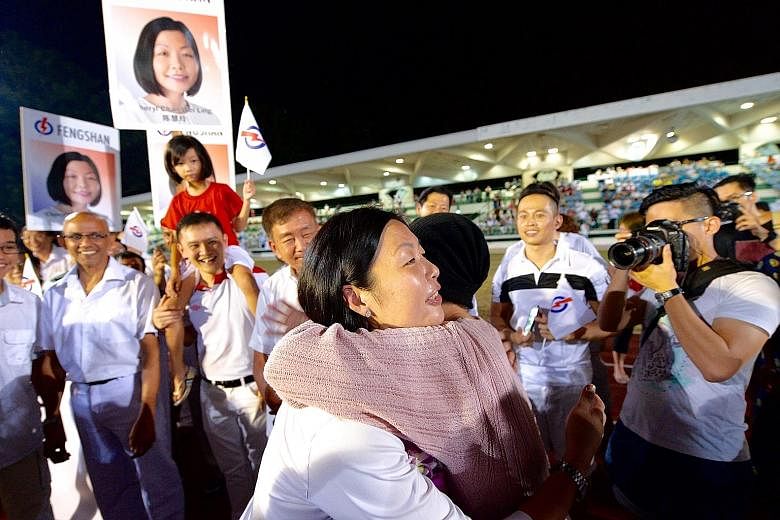 Ms Cheryl Chan getting a congratulatory hug last night after being declared the winner for Fengshan.