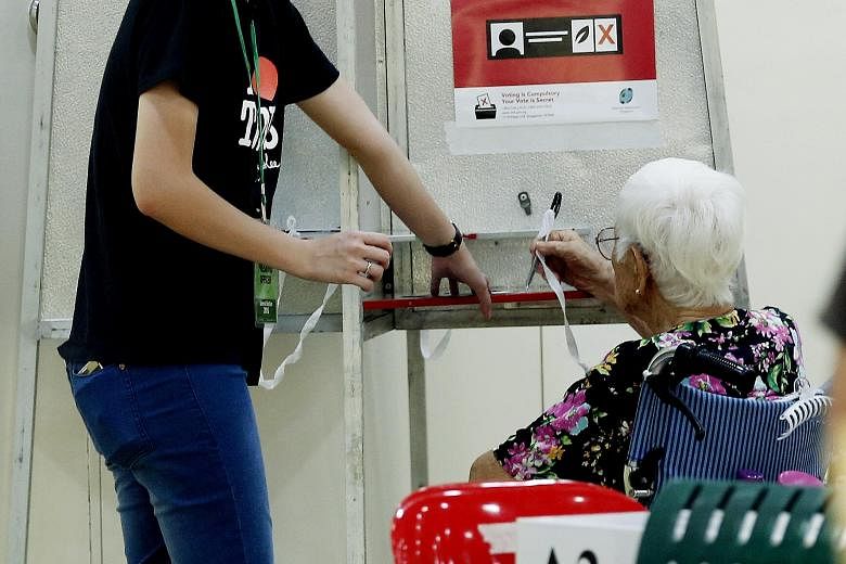 Resident Ho Ku Wan, 94, casting her vote at a polling station in Toa Payoh. Since GE2011, the PAP has provided more help for the low- and middle-income groups as well as the elderly.
