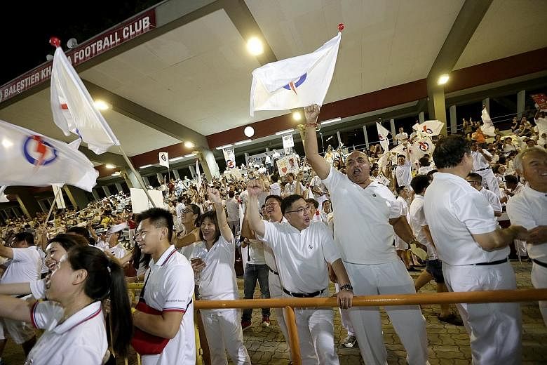 Jubilant PAP supporters at Toa Payoh Stadium cheering as the results are announced.