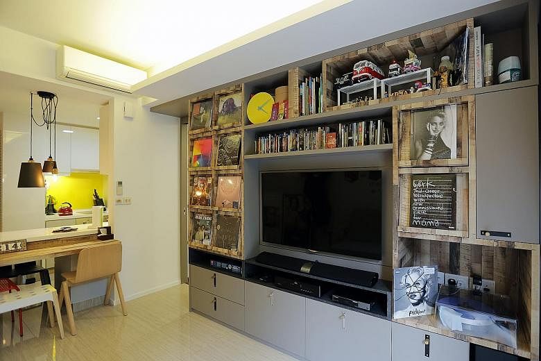 Customised display and storage spaces in the home of Mr Darrin Yok (above) help show off his record collection. (Left) His living room and dining area. A swivel wall for the television set lets the owner watch shows from the comfort of his bedroom (a