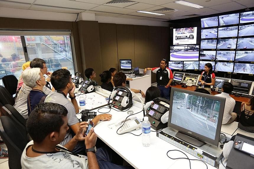 ST readers enjoy a rare chance to be at the starting line and control room (far left). The race here has been labelled the crown jewel of Formula One.