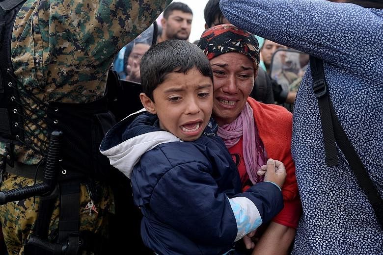 Migrants breaking through a police cordon in Gevgelija in Macedonia. As the migration crisis overwhelms Europe, critics are accusing the Arab world's richest nations of not doing enough to help out.