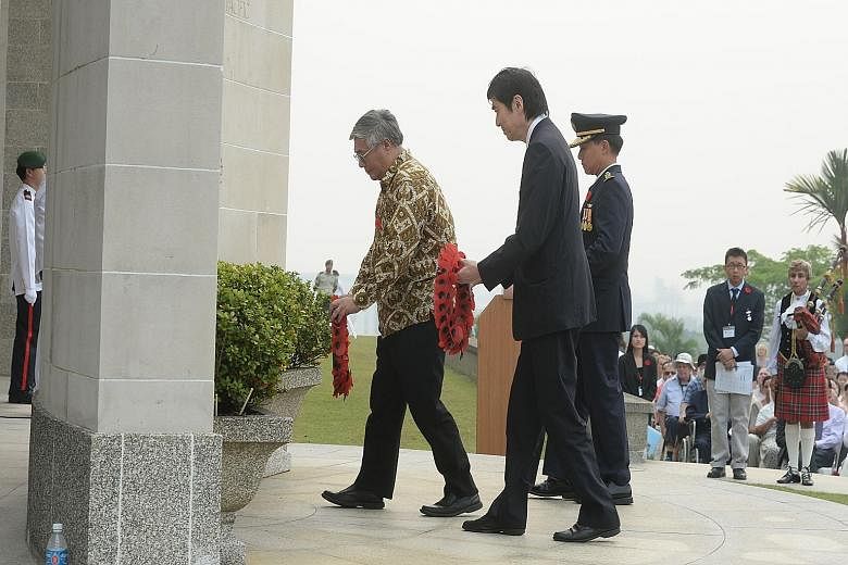 (Far left) Prof Walter Woon, Japanese Ambassador Haruhisa Takeuchi and Colonel Joseph Tan Boon Kiat, Director Nexus of the Defence Ministry, laying wreaths during the remembrance ceremony (left), which was held by The Changi Museum at the Kranji War 