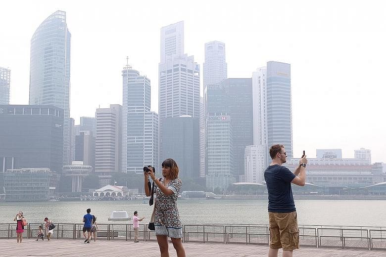 The financial district was shrouded in haze yesterday afternoon. The 24-hour PSI was within the moderate range of 51 to 100 for most of yesterday before creeping into unhealthy levels in the evening.