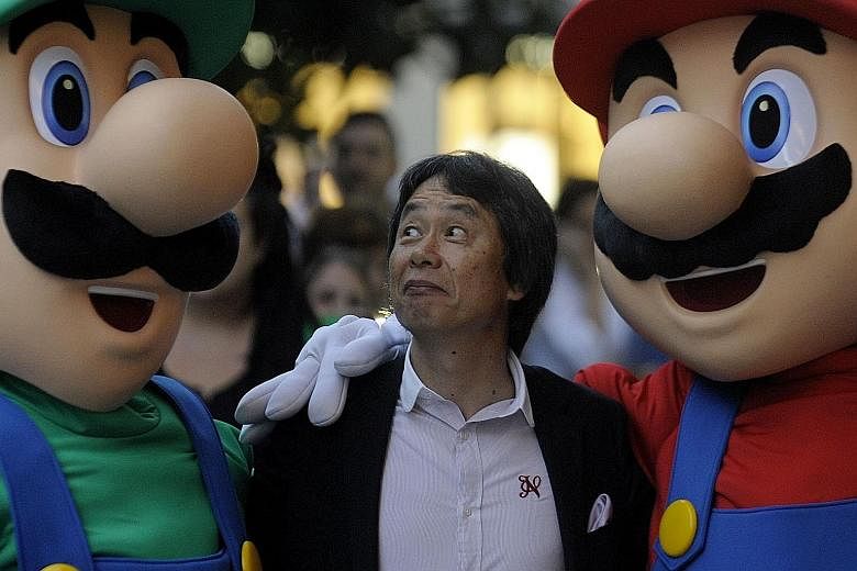 Mario's creator Shigeru Miyamoto posing with the game's iconic stars Mario and Luigi. To mark 30 years since its initial launch, Nintendo is releasing a new version of the game with a creative format.