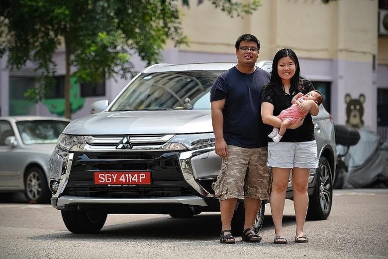 Off-peak car owner Jeosiah Wee, with his wife Clarissa and their child. He says the car is mainly for weekends and taking the family out.
