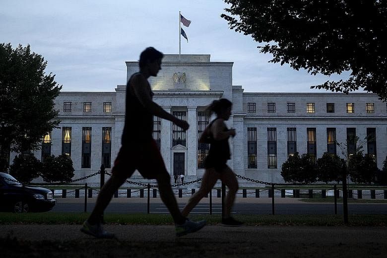 Pedestrians walking past the Federal Reserve building in Washington, DC. It's not a question of whether the Fed raises rates or not but when, says Mr Tim Ghriskey, chief investment officer of Solaris Group in New York.