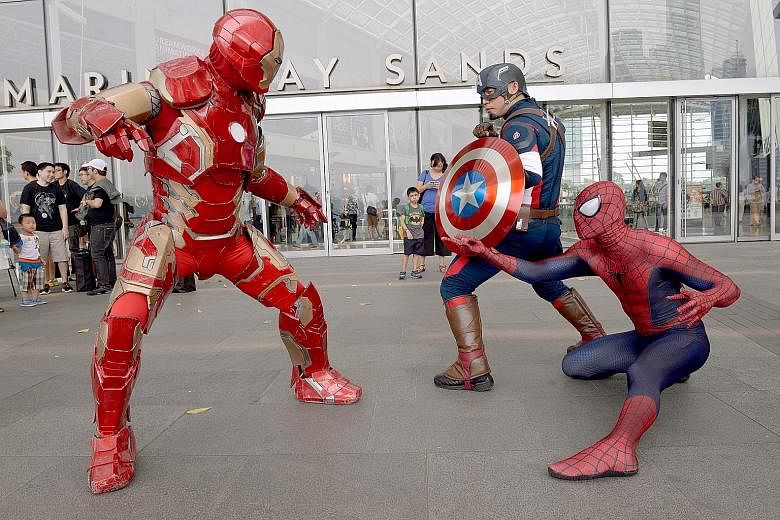 East and West: Iron Man (above, left) battles Captain America (centre) and Spiderman (right).