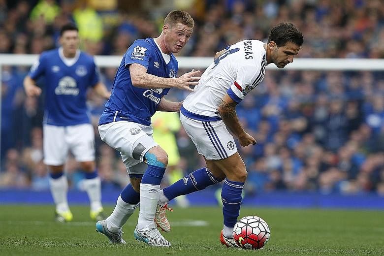 Cesc Fabregas (right), harried by Everton's James McCarthy, was as ineffectual as other team-mates in the 1-3 loss to Everton on Saturday.