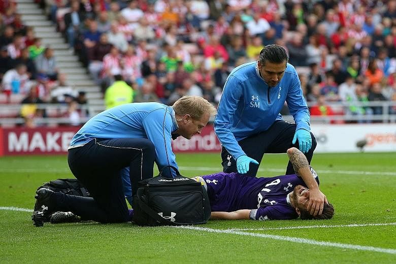 Tottenham midfielder Ryan Mason receiving medical attention after scoring the winner against Sunderland yesterday.
