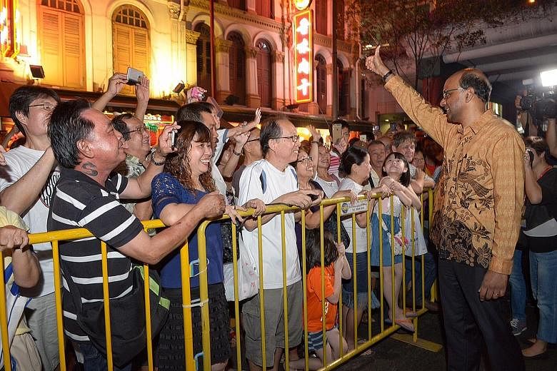 Mr Tharman greeting the crowd at the launch of the Mid-Autumn Festival celebrations in Chinatown yesterday. He said Singapore must remain a society with diverse voices, not just during the elections.