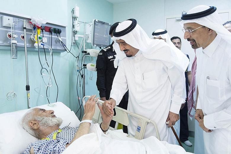 Saudi King Salman visiting one of the victims at a hospital in the Muslim holy city of Mecca on Saturday. The king also went to the site of the crane collapse at the Grand Mosque and promised a thorough investigation into the tragedy.
