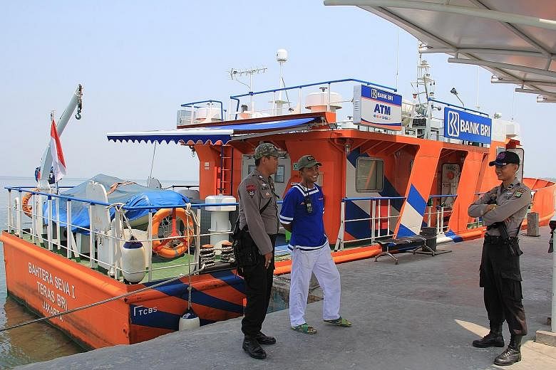 This floating bank, owned and operated by state-bank BRI, has an air-conditioned banking cabin staffed by up to four bank employees and an ATM; Madam Ningsih (above left) gets her banking done on the boat, saving her the bother of travelling from Unt
