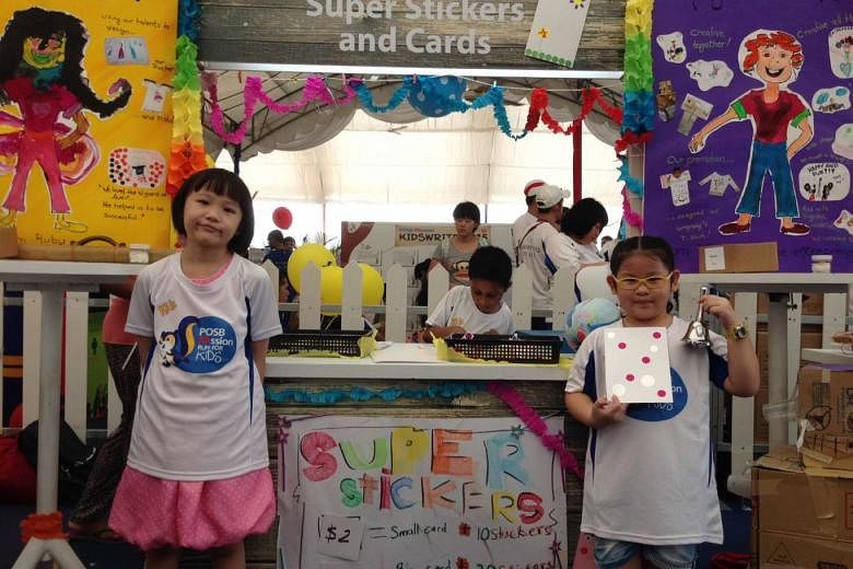 Seven-year-old Seet Jiaxin at her booth, where she sold cards made from drawing paper and stickers. 