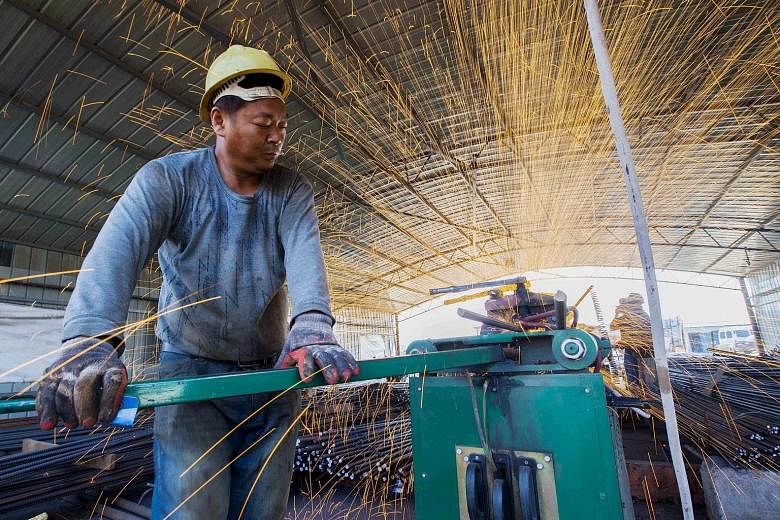 A labourer at work at a railway bridge construction site in Lianyungang in China's Jiangsu province. The country's swelling debt pile is at odds with Premier Li Keqiang's vow to rebalance the economy and reform bloated state-owned enterprises.