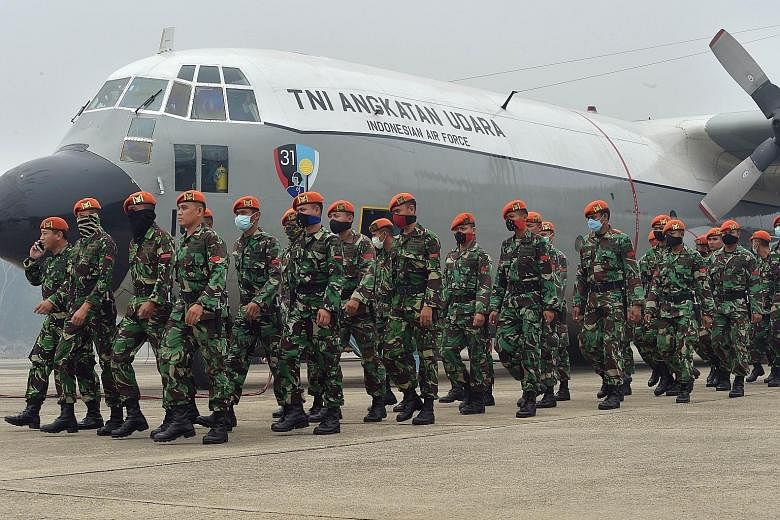 Air force personnel arriving yesterday to help firemen combat fires in Pekanbaru, Riau province.