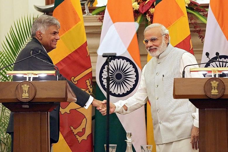 Sri Lankan Prime Minister Ranil Wickremesinghe (far left) and Indian Prime Minister Narendra Modi (left) during a joint press conference in New Delhi on Tuesday. Mr Wickremesinghe was on a three-day visit to India.