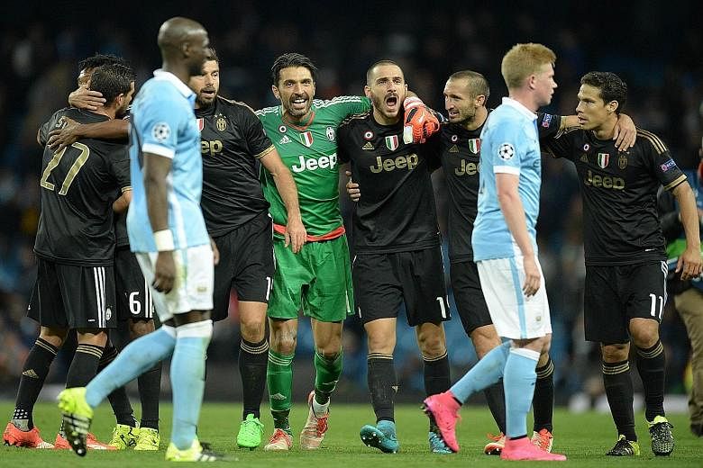Juventus goalkeeper Gianluigi Buffon (centre), who had an outstanding match, celebrating with his team-mates after their victory over Manchester City.