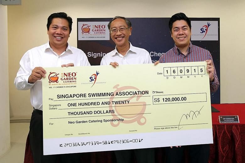 Neo Garden Catering CEO Neo (left) presenting the cheque to SSA president Lee (centre) and SSA executive director Edwin Ker yesterday. The money will boost the association's grassroots and other development programmes.