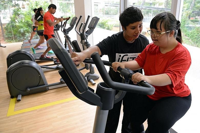 Singapore's first "inclusive" gym - open to everyone, including people with disabilities and the elderly - officially opened in Lengkok Bahru yesterday. Among the first to try out the gym equipment was Ms Felicia Lee, 23, (right), who has an intellec