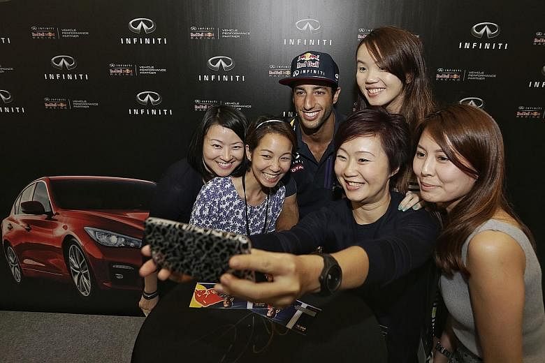Red Bull driver Daniel Ricciardo with fans during an Infiniti event at Paragon yesterday. He said Mercedes are "just too strong" but feels Red Bull can "definitely get close" to Ferrari.
