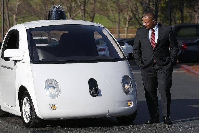 Mr John Krafcik (above) now heads Google's self-driving car division. The car being inspected by United States Transportation Secretary Anthony Foxx (top) earlier this year.