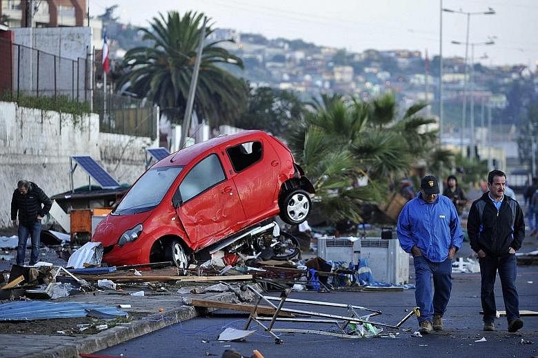 A car wrecked by strong waves which slammed into the shore during Wednesday's earthquake in Coquimbo port city. The magnitude-8.3 quake was the world's strongest this year and the biggest to hit Chile since 2010. One million people were forced to eva