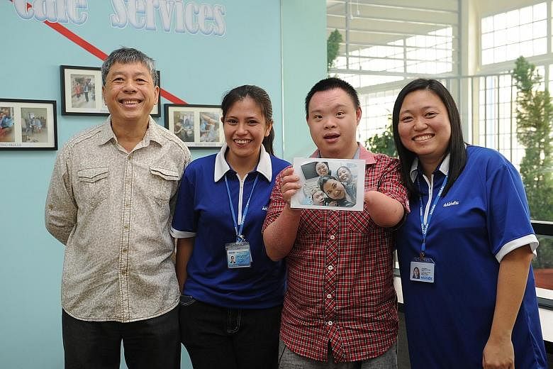 Mr Liew Chong Pow (far left) with his son Jonathan and Minds staff (from left) Joie Aludino and Koh Chu Wen at the group's new facility at Kembangan-Chai Chee Community Hub. The building houses a Caregivers Support Services Centre and a day activity 