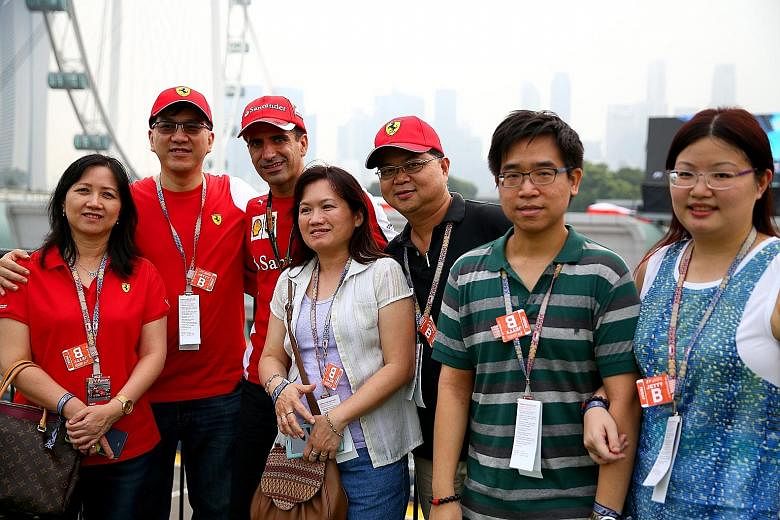 Ferrari test driver Marc Gene (third from left) with the winners of The Straits Times-Shell contest, who were hosted at the Shell Sky Suite and toured Shell's trackside laboratory and Ferrari's pit garage.