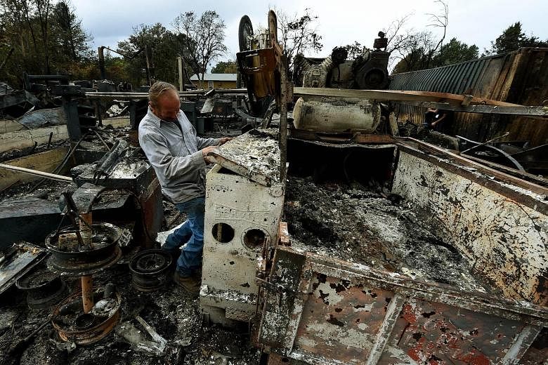 The NOAA report comes as wildfires in California continue to wreak havoc amid a sustained drought that some have linked to climate change. Right and far right: What's left of Mr Larry Menzio's tyre shop after the so-called Valley Fire swept through t