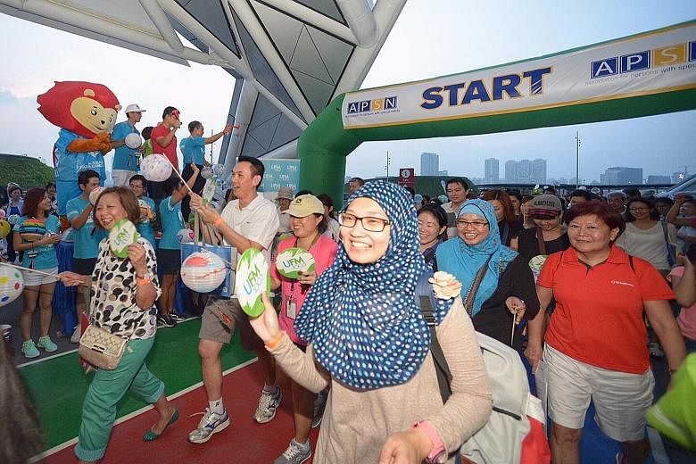 The haze did not cloud the enthusiasm of participants in a 1.4km walkathon at the Singapore Sports Hub, organised by the Association for Persons with Special Needs.