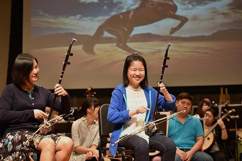 Ms Ow (in blue) rehearsing with the Singapore Chinese Orchestra.