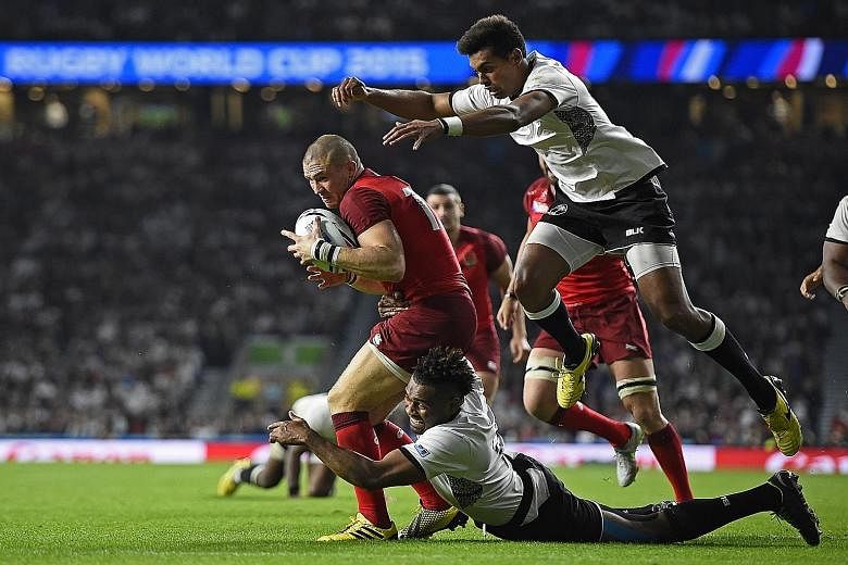 England's Mike Brown (in red) scores his second try against Fiji. England are in a so-called group of death that includes world top-10 sides Wales and Australia.
