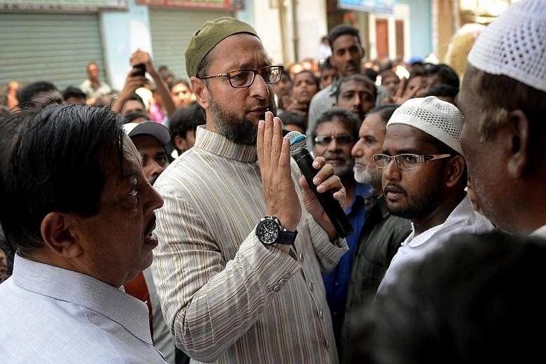 Mr Asaduddin Owaisi (centre) and his firebrand style of politics are catching the ear of many Indian Muslims.