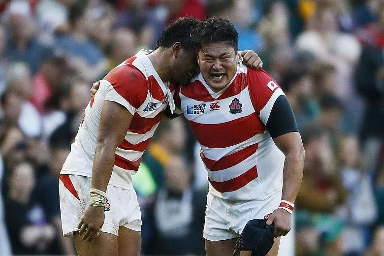 An emotional moment for Japan's Amanaki Mafi (left) and Hiroshi Yamashita at the end of the game.
