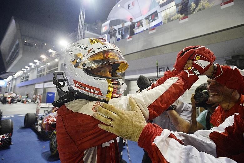 A jubilant Sebastian Vettel celebrates with the Ferrari team after his win last night. Before taking his place on the podium, he bent down to kiss the car that carried him to victory.