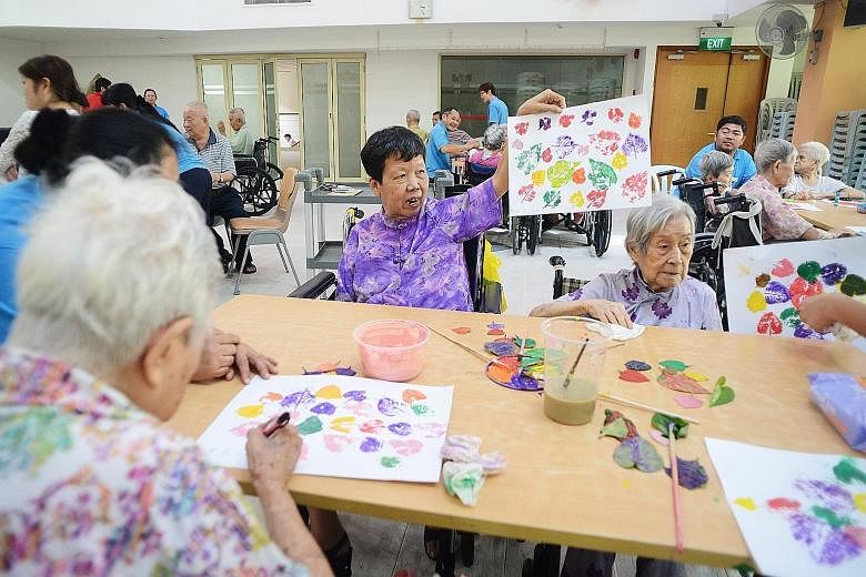 Ms Juan Po Giok (centre), 65, enjoying a visual arts session at the Ling Kwang Home for Senior Citizens last month. The former seamstress has attended several such sessions as she likes working with her hands.