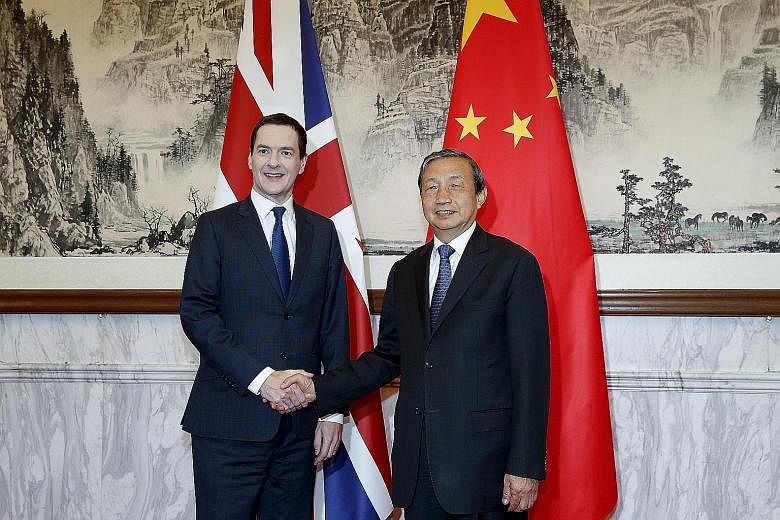 British Chancellor of the Exchequer George Osborne (left) with Chinese Vice-Premier Ma Kai yesterday in Beijing. Mr Osborne said the study on the equity link will be discussed by the next round of the annual talks.
